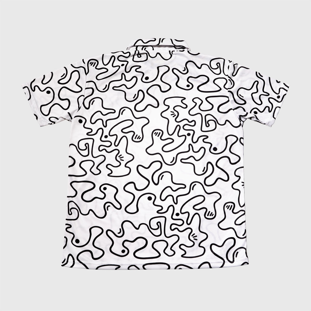 Black / White polo t-shirt, lightweight breathable fabric, squiggle graphic, and embroidered MAD TASTY logo in top right corner. 