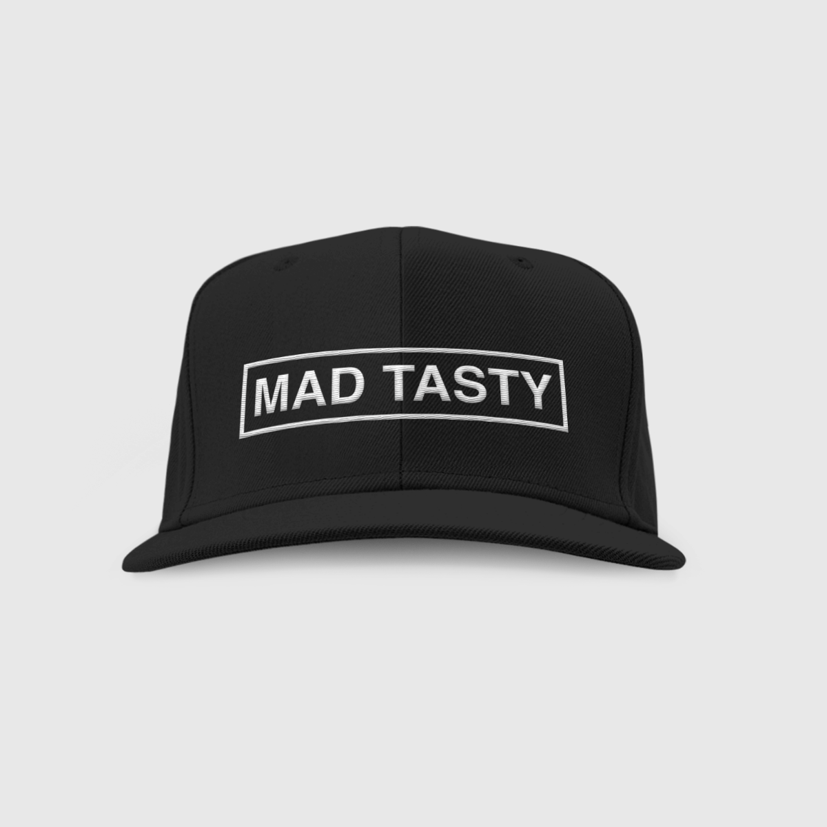 Baseball hat with MAD TASTY logo embroidered on front in white.