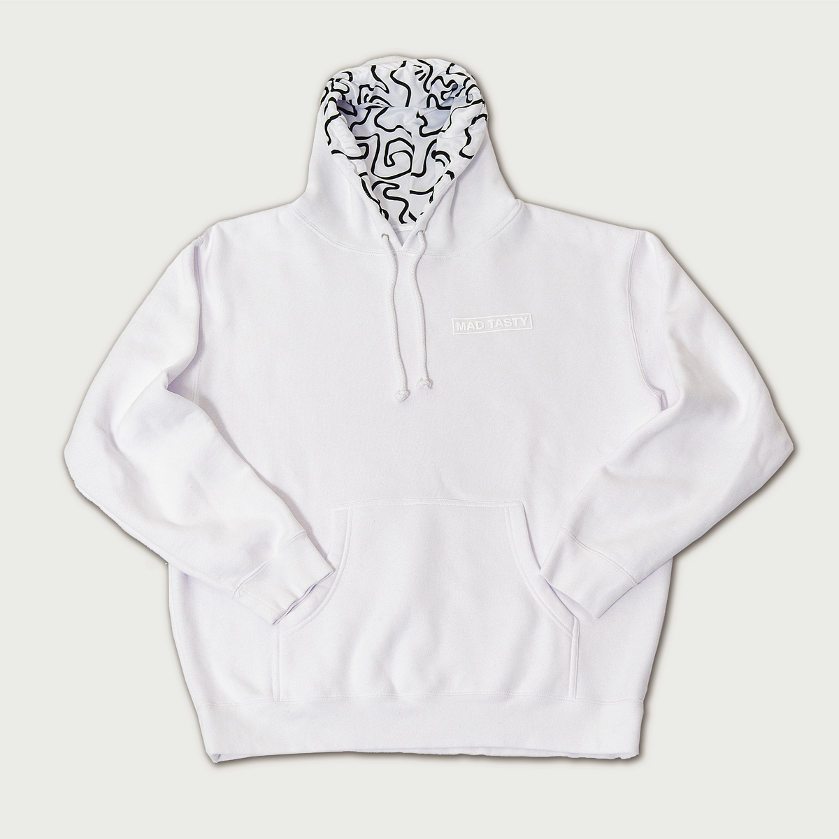 https://madtasty.com/cdn/shop/products/MADTASTYMERCH_WhiteSquiggleHoodie_Web_1200x.png?v=1637943828