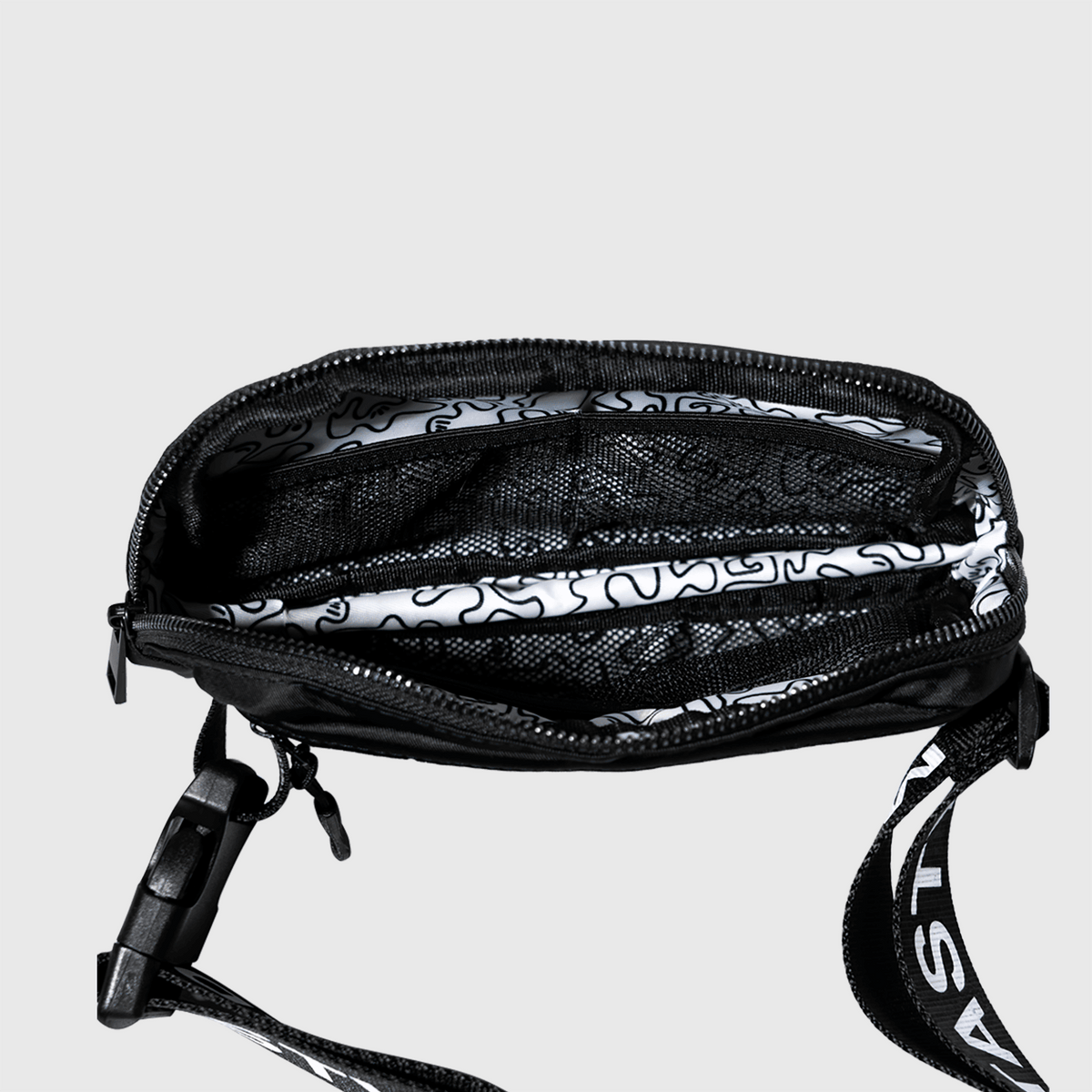 MAD TASTY custom black fanny pack with adjustable strap, zipper closer, outside and inside pockets. MAD TASTY logo on front and straps, with squiggles on inside liner.