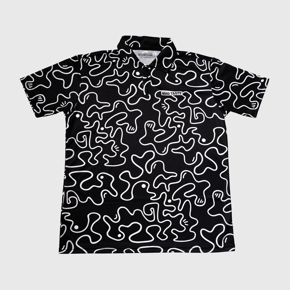 Black / White polo t-shirt, lightweight breathable fabric, squiggle graphic, and embroidered MAD TASTY logo in top right corner. 