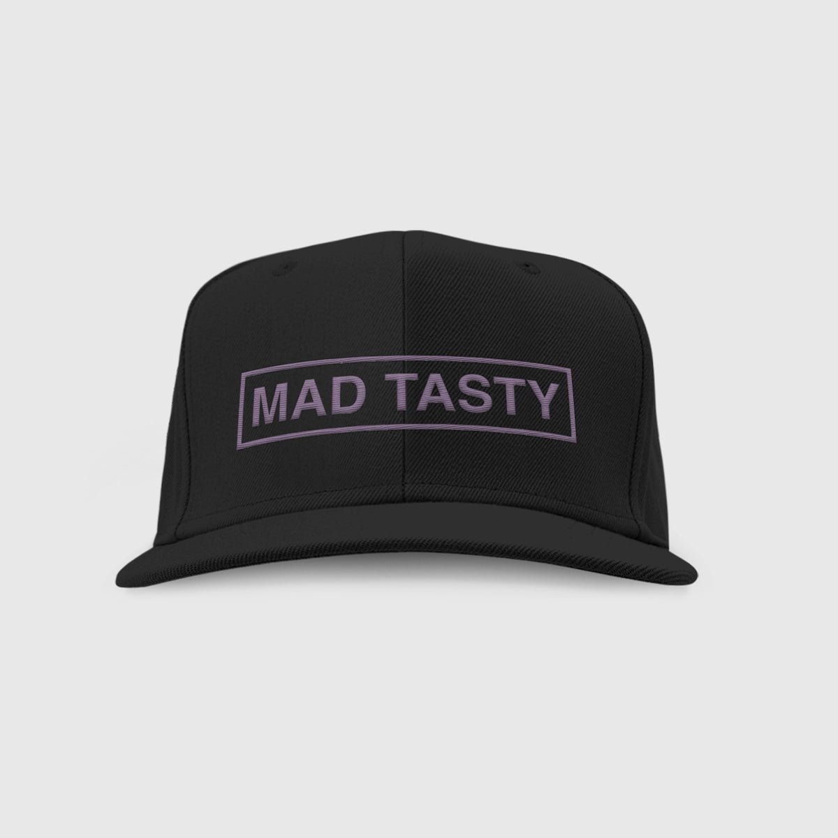 Baseball hat with MAD TASTY logo embroidered on front in grey.